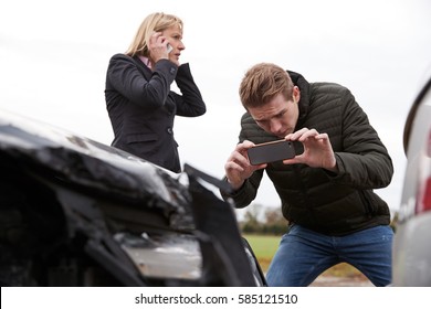 Drivers Taking Photo Of Car Accident On Mobile Phones