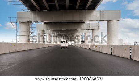 Driver's view of a double-decker portion of Skyway Stage 3, an elevated expressway. Traffic lanes have not been painted yet. In Metro Manila, Philippines.