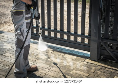 Driveway And A Gate Pressure Washing. Cleaning House Surroundings.