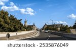 Driving Across Adolphe Bridge toward Spuerkeess Building on a Clear Summer Day - Luxembourg City