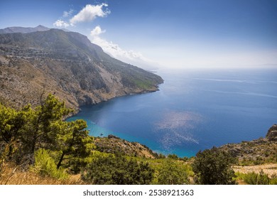 Driving along Croatia’s coastline on a clear day offers stunning views of turquoise waters, rocky cliffs, and charming villages. The sun-lit Adriatic sparkles beside winding scenic roads. - Powered by Shutterstock