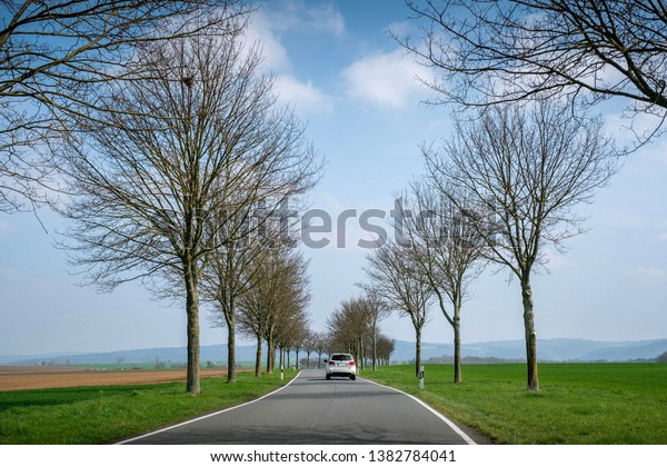 Driving along the road\
in spring in Wierschem, Germany. The route goes to Eltz castle.\
Road trip in Europe.