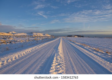 Driving along a straight road in a snow covered landscape