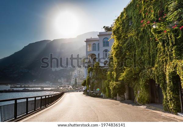 Driving\
around the Amalfi Coast on a scooter,\
Italy