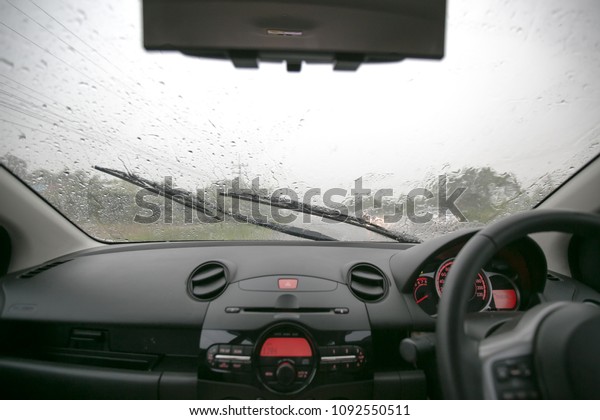 Driving in bad\
weather requires heavy driving. Slippery road while opening wipers\
are running. View from the inside of the carmust be driving with\
caution.Some Cars turn on the light.\
