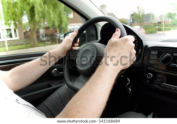 Driving with both\
hands on the steering\
wheel