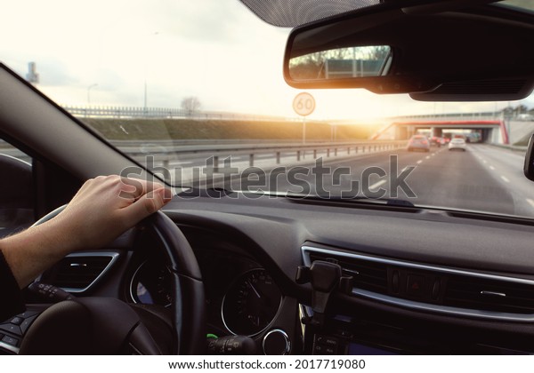 Driving a car in the\
city on a sunny day