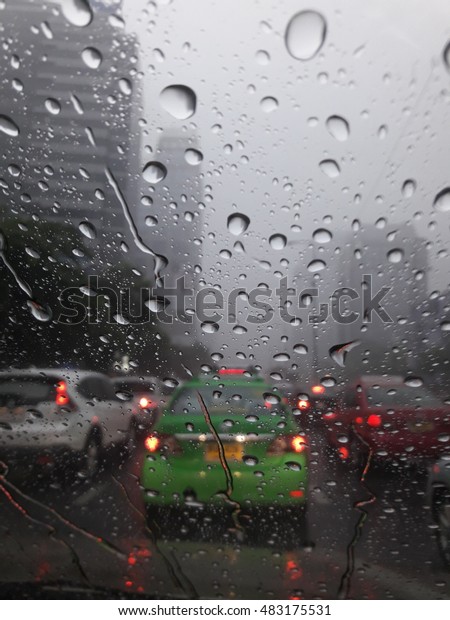 Driving car in the city with\
rain