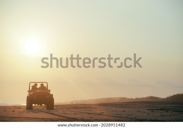 driving a car with friends while on vacation at\
sunset beach