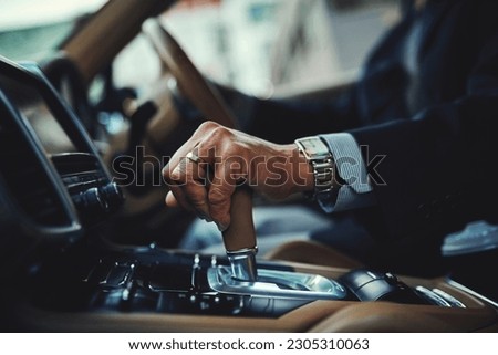 Driving, car and gear with hand of man for manual, transportation and engine. Luxury, test drive and safety with closeup of male driver in vehicle for commute, travel and automobile transmission