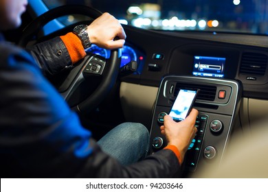 Driving A Car At Night -man Driving His Modern Car At Night In A City (shallow DOF; Color Toned Image)