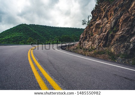 Driving a car on empty mountain scenic winding road. Cape Breton, Cabot Trail, Nova Scotia, Canada.