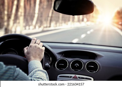 	Driving car on empty road - Shutterstock ID 221634157