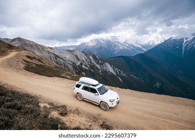 Driving car on high altitude mountain trail, China
