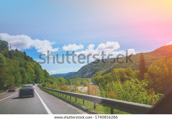 Driving a car on mountain road. Journey by car.\
View from windscreen of mountain landscape. Carpathian mountains,\
Ukraine, Europe