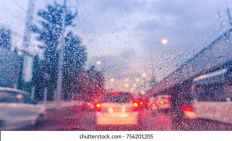 Driving Car On The Road In Trafic Jam With Raindrop Over The Wind Shield, Rainy Season