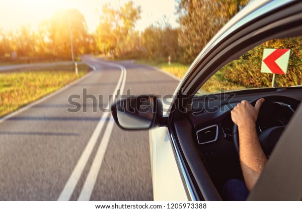 Driving a car on a winding\
road