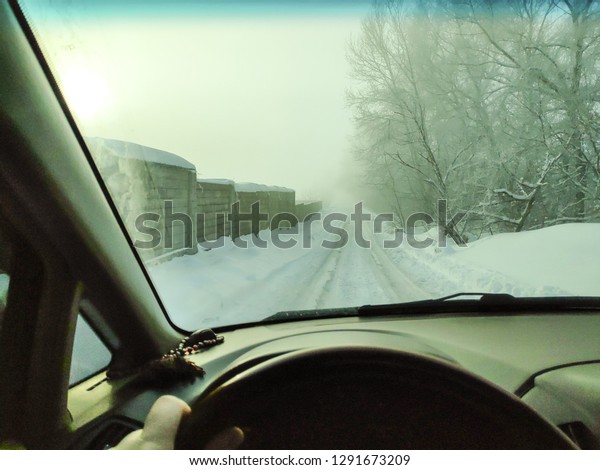 driving in a car on a winter road, winter road,\
inside a car, a lot of\
snow