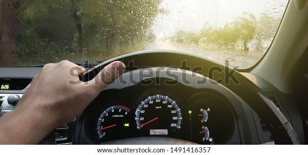 Driving car in the rain on wet road, Rainy weather\
through the car window,\
