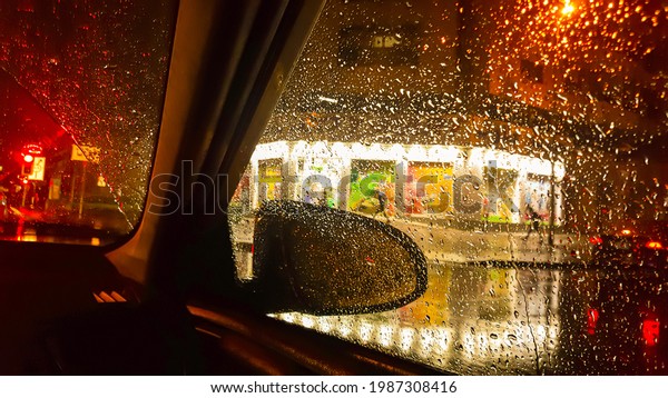 
Driving
a car in rainy day after rain drop. Rain drops on car window. Be
careful and safe drive. Cars stop waiting for signal lights in the
city. In side view mirror. Traffic in rainy
day