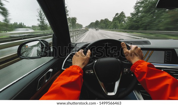 Driving car at a rainy day on a highway - POV, first\
person view shot
