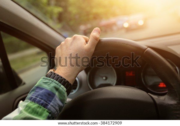 Driving a car in a sunny\
day