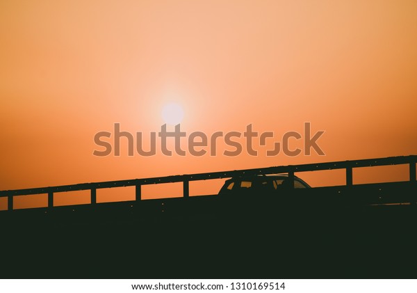driving a car at sunset on the highway -  car\
travel concept