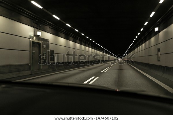 Driving car in tunnel, transport background, safety\
on the road