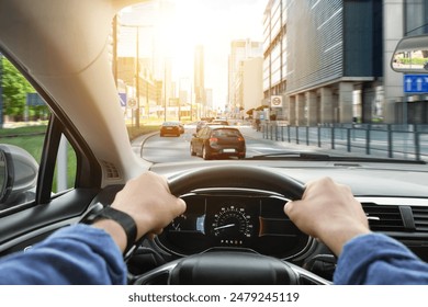 Driving car, view from driver's seat. Man holding hands on steering wheel, closeup - Powered by Shutterstock