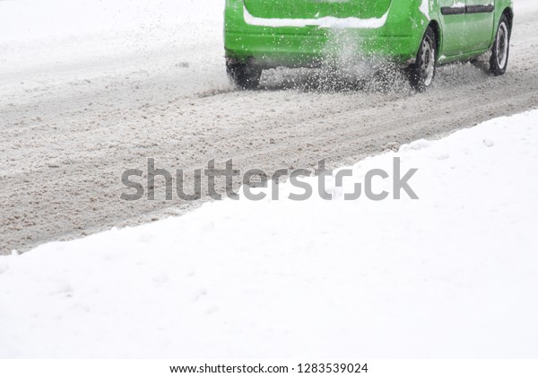 Driving a car in the winter \
with snow on the road. Concept of driving in extreme weather\
conditions