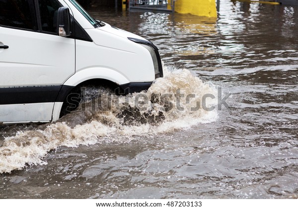 Driving cars on a flooded road during flooding\
caused by torrential rains. Cars float on water flooded streets.\
The disaster in Odessa