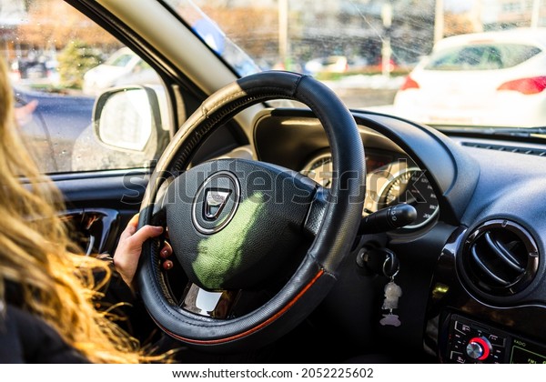 Driving\
Dacia, close up of dashboard, steering wheel with air bag sign.\
View of car interior in Bucharest, Romania,\
2021