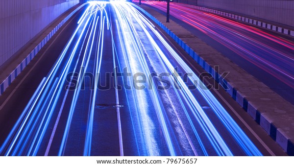 Driving fast\
lights trails from cars, blue\
toned