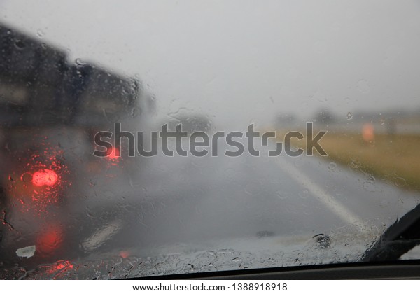Driving\
in heavy rain, reduced visibility. Blurred\
image