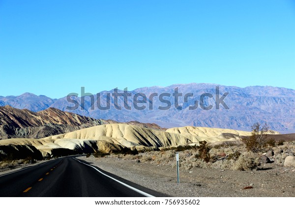 driving in the historical route 66 near Death Valley\
in Nevada in USA.