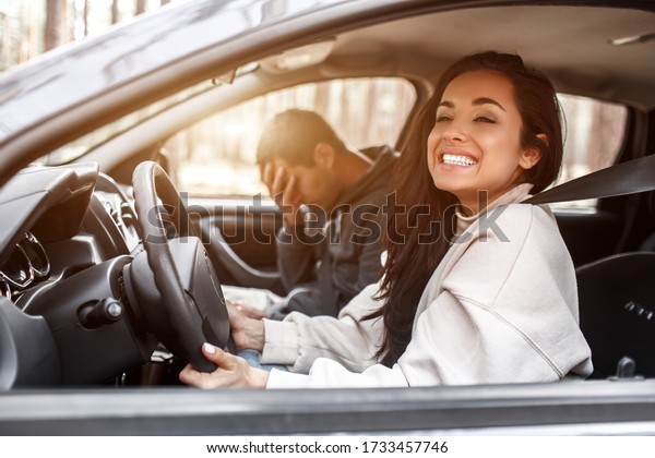 Driving instruction. A young woman learns to drive a\
car . Her instructor or boyfriend doesn\'t like the way she drives a\
car. But the girl is pleased with herself and does not listen to\
the guy.