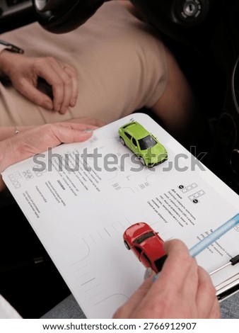 The driving instructor demonstrates how to park properly using toy cars