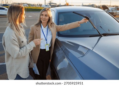 Driving instructor explaining car features to learner during practical lesson