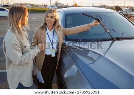 Driving instructor explaining car features to learner during practical lesson