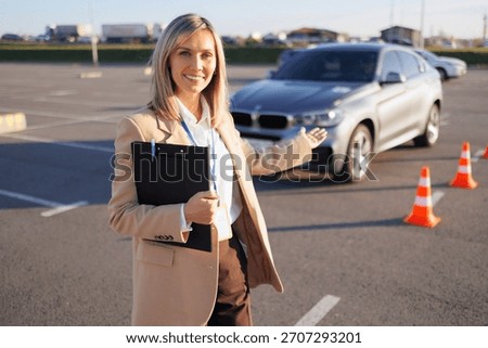 Driving Instructor Presenting Training Car and Course Cones
