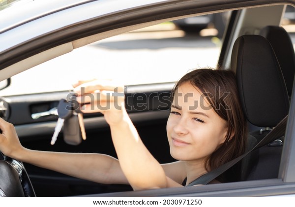 driving instructor,\
student driver at a driving school takes an exam in a car to obtain\
a driver\'s license