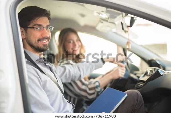 Driving instructor is teaching his student how to\
drive a car