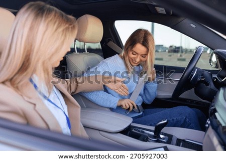 Driving Instructor Teaching Student to Properly Buckle Seatbelt Before Test