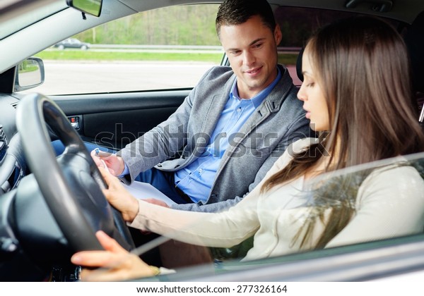 Driving
instructor and woman student in examination
car