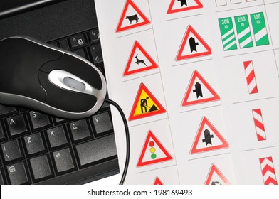 Driving licence online concept with computer and traffic signs