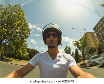 Driving A Motorbike On Summer. POV Selfie. Young Adult Man Driving A Motorbike In The City On A Sunny Summer Morning