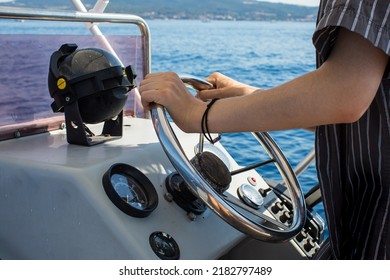Driving motorboat on holiday. Man sailing an inflatable rubber motor boat on the sea. Boat rental close up