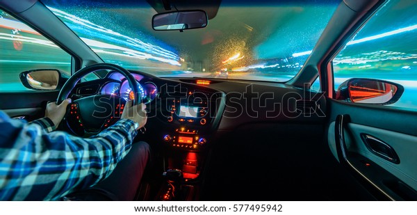 Driving in night scenery, hands on steering wheel,
night rain time