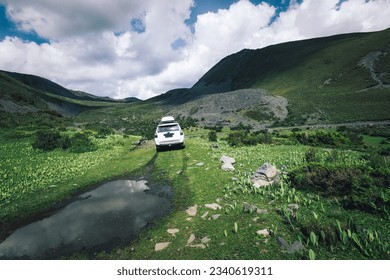 Driving off road car in high altitude mountains in Sichuan province, China