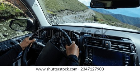 Driving off road car in high altitude mountains in Sichuan province, China